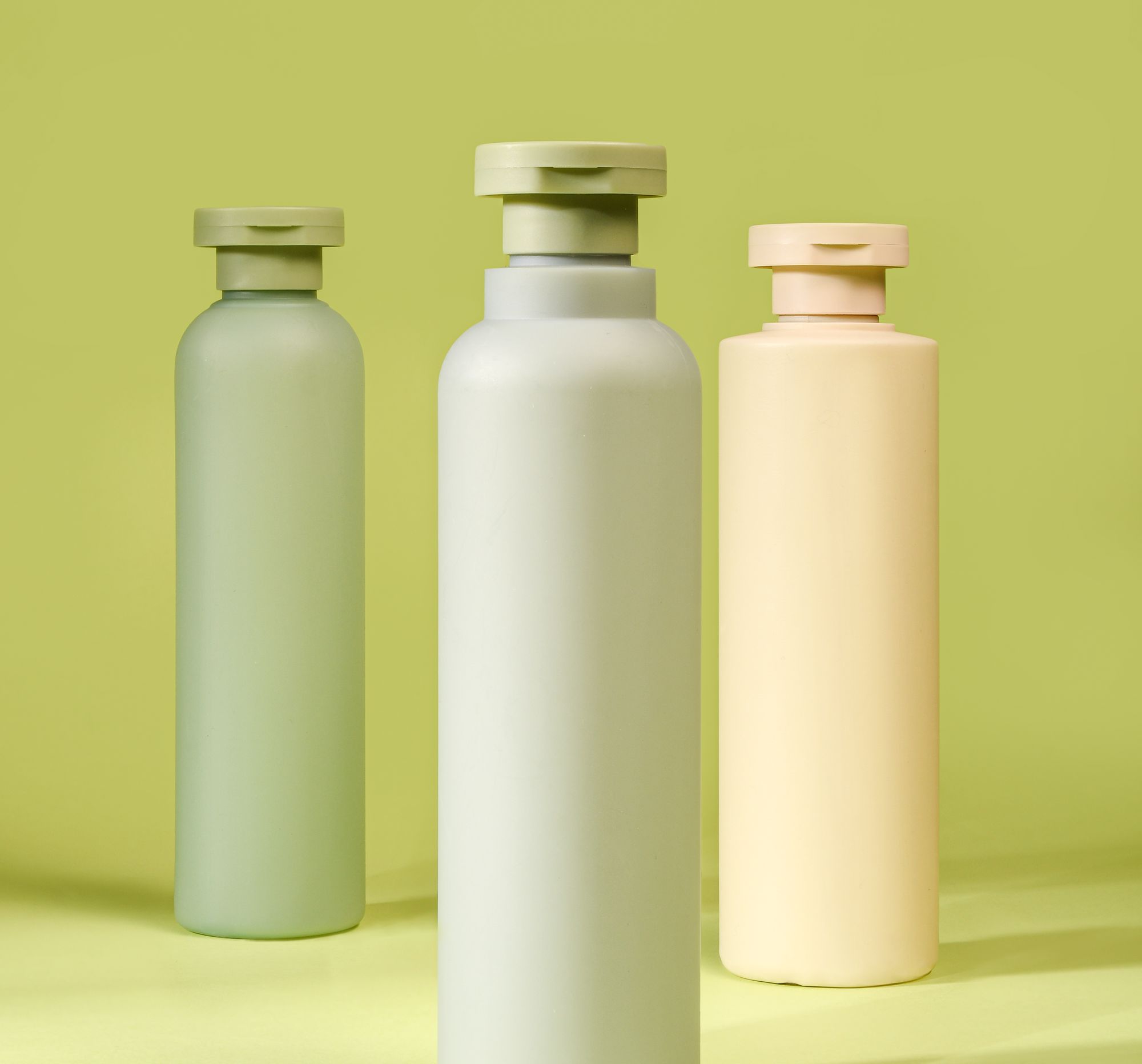 Pastel green and cream cosmetic bottles